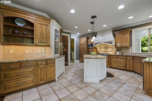 24800 SW Big Fir Rd, West Linn, OR 97068 - kitchen with custom exhaust hood, crown molding, stainless steel microwave, decorative backsplash, and recessed lighting