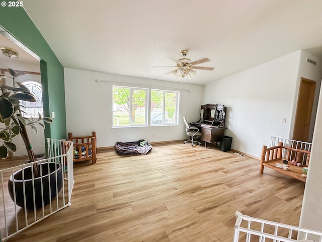 living room featuring a desk, wood finished floors, a ceiling fan, and baseboards