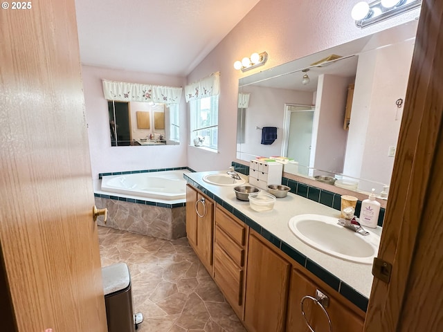full bath with a stall shower, a bath, double vanity, and lofted ceiling