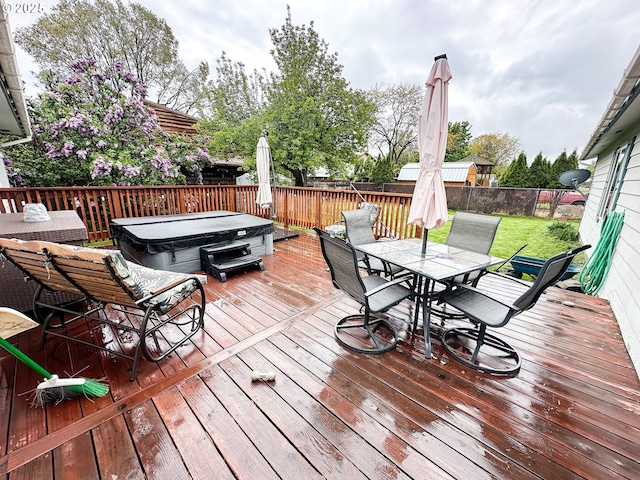deck with outdoor dining area and a fenced backyard