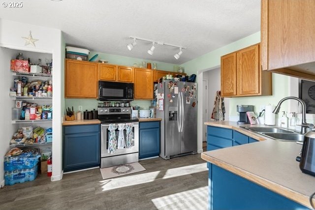 kitchen featuring stainless steel appliances, dark hardwood / wood-style flooring, and sink