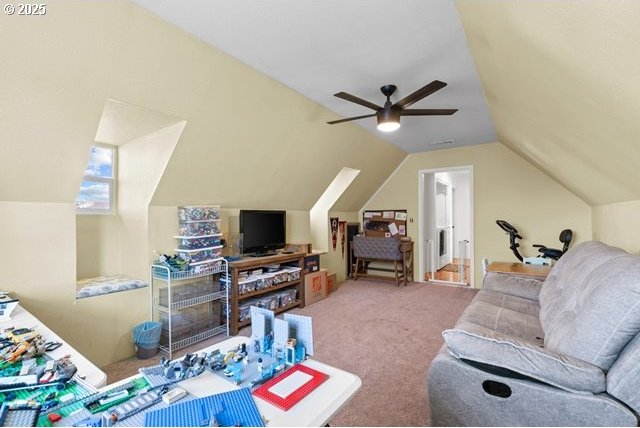 living room with lofted ceiling, carpet floors, and ceiling fan