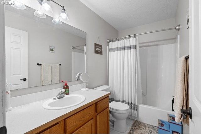 full bathroom featuring vanity, a textured ceiling, toilet, and shower / bath combo