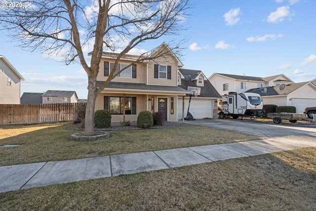 view of property with a garage, a porch, and a front yard