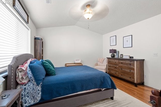 bedroom featuring hardwood / wood-style flooring, ceiling fan, and lofted ceiling