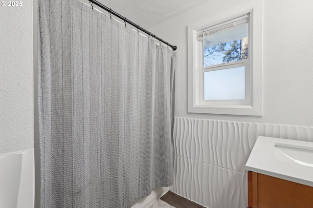 bathroom featuring vanity, a textured ceiling, and a shower with shower curtain