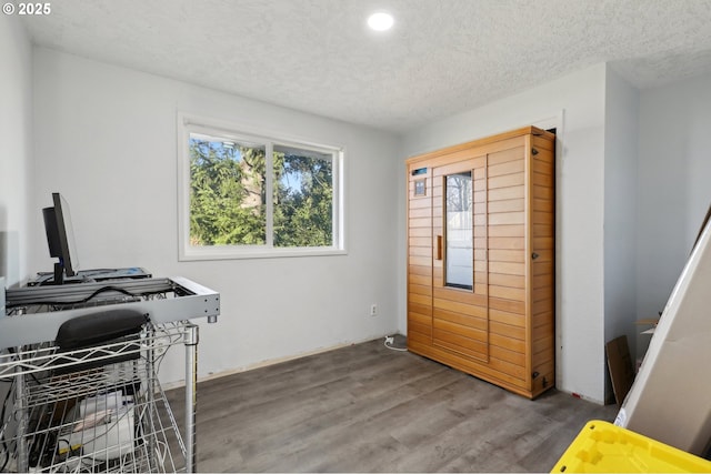 home office featuring hardwood / wood-style flooring and a textured ceiling