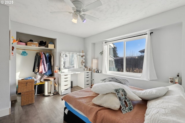 bedroom featuring dark hardwood / wood-style flooring, a closet, and ceiling fan