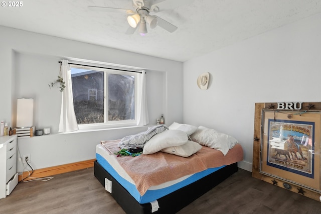 bedroom with wood-type flooring and ceiling fan