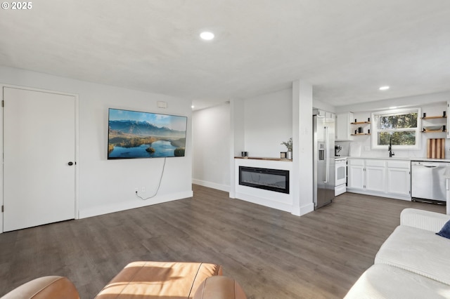 unfurnished living room with dark wood-type flooring