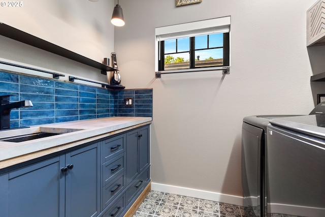 22961 SE Filbert Rd, Eagle Creek, OR 97022 - laundry room with washer and clothes dryer, cabinet space, and baseboards