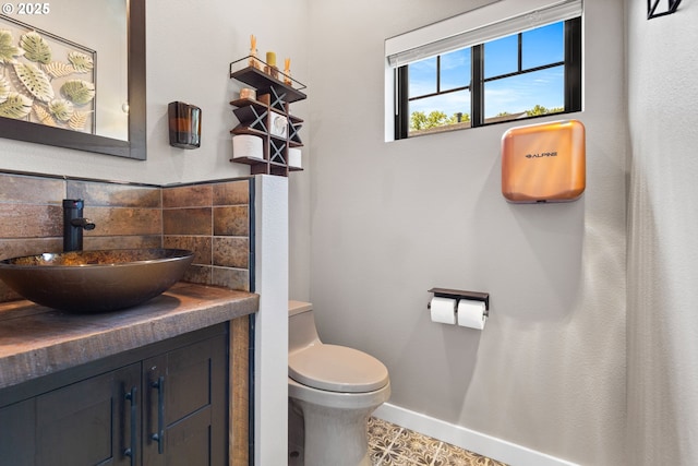 22961 SE Filbert Rd, Eagle Creek, OR 97022 - bathroom with vanity, toilet, baseboards, and decorative backsplash
