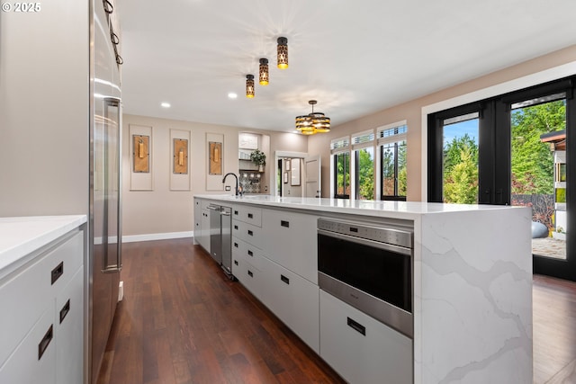 22961 SE Filbert Rd, Eagle Creek, OR 97022 - kitchen with stainless steel appliances, recessed lighting, dark wood finished floors, white cabinetry, and french doors