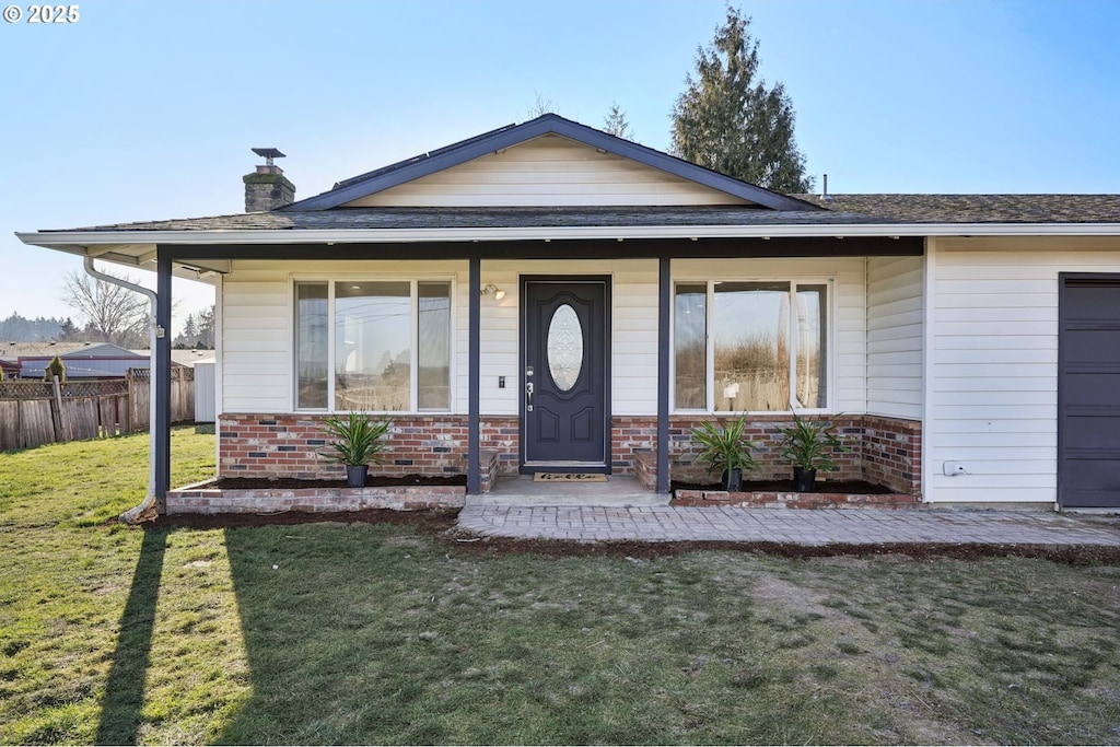 view of front of home with a porch and a front lawn