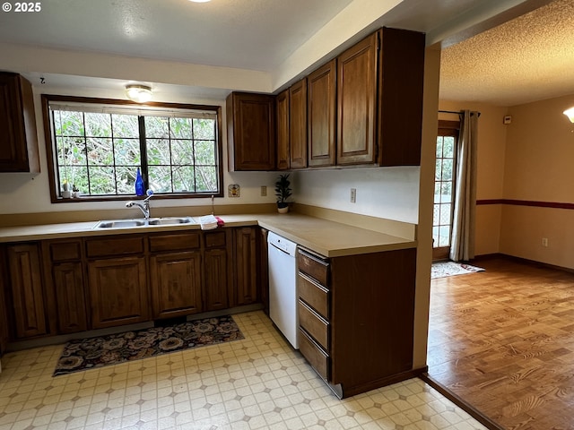 1011 Heather Ct, Reedsport, OR 97467 - kitchen featuring white dishwasher, light countertops, light floors, and a textured ceiling