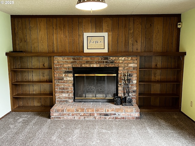 1011 Heather Ct, Reedsport, OR 97467 - detailed view of carpet floors, wood walls, a fireplace, and a textured ceiling