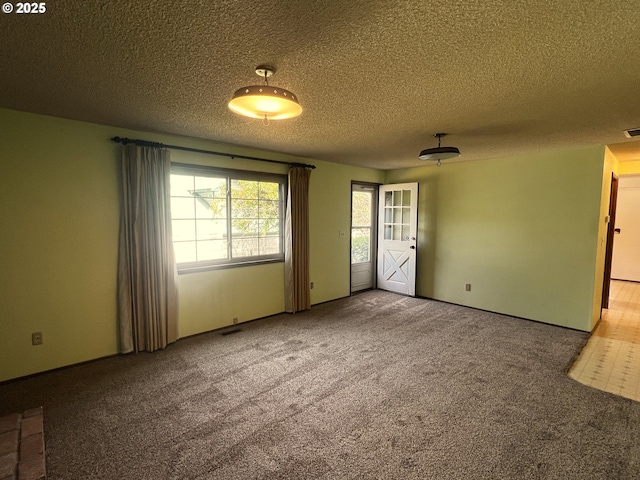 1011 Heather Ct, Reedsport, OR 97467 - carpeted spare room with a textured ceiling