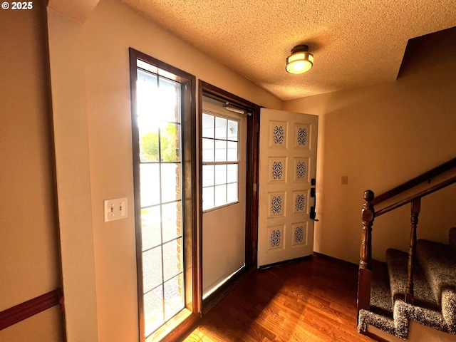 1011 Heather Ct, Reedsport, OR 97467 - foyer entrance with stairway, a textured ceiling, and wood finished floors