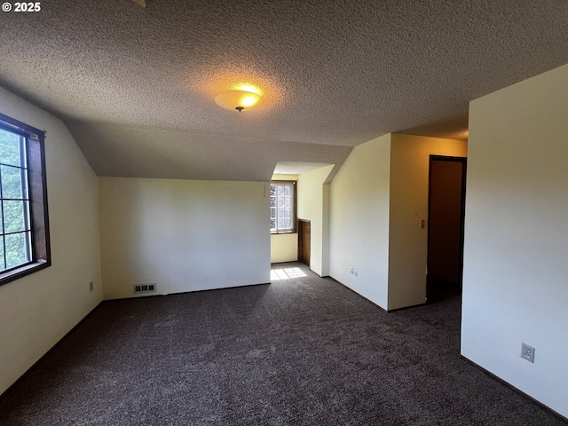 1011 Heather Ct, Reedsport, OR 97467 - additional living space with carpet flooring and a textured ceiling