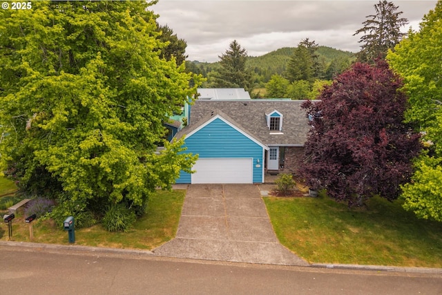 1011 Heather Ct, Reedsport, OR 97467 - view of front facade with a garage, a front yard, driveway, and a shingled roof