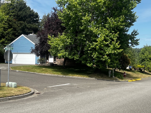 1011 Heather Ct, Reedsport, OR 97467 - view of front of house featuring a garage, a front lawn, and driveway