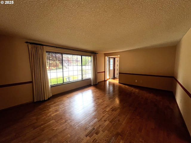 1011 Heather Ct, Reedsport, OR 97467 - empty room with wood finished floors and a textured ceiling