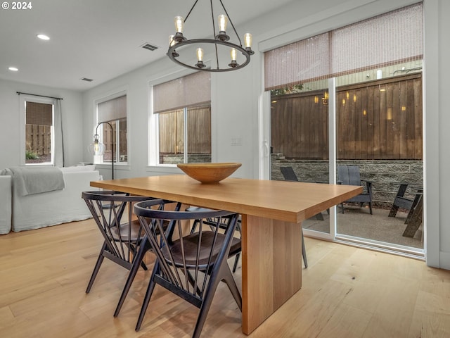 interior space featuring an inviting chandelier and light hardwood / wood-style flooring