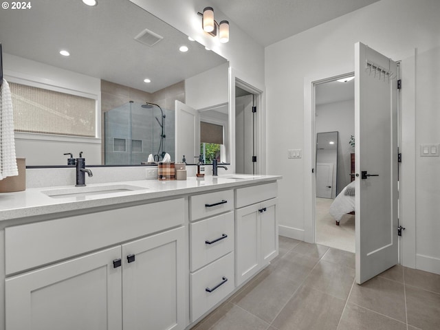 bathroom featuring vanity, tile patterned floors, and walk in shower