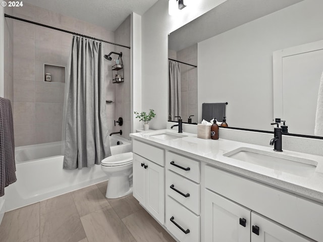 full bathroom with vanity, a textured ceiling, toilet, and shower / bath combo