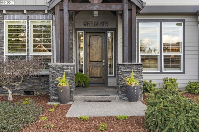 doorway to property with stone siding