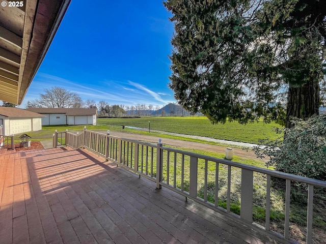 wooden deck with a lawn, a mountain view, and a rural view