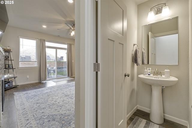 bathroom with hardwood / wood-style flooring and ceiling fan