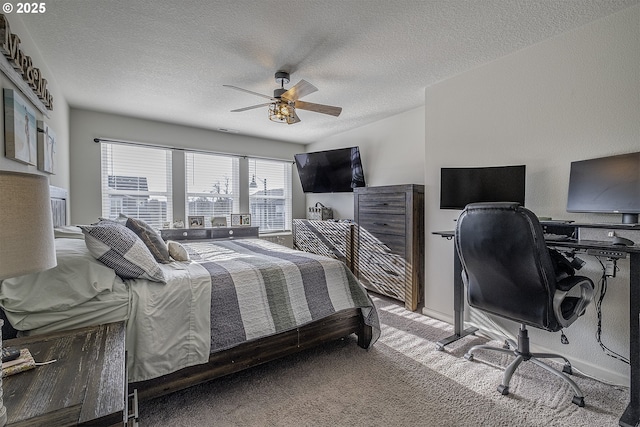 carpeted bedroom with ceiling fan and a textured ceiling