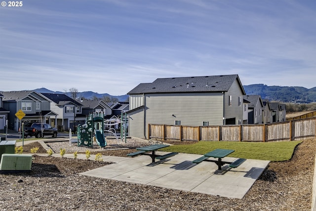 exterior space featuring a playground and a mountain view