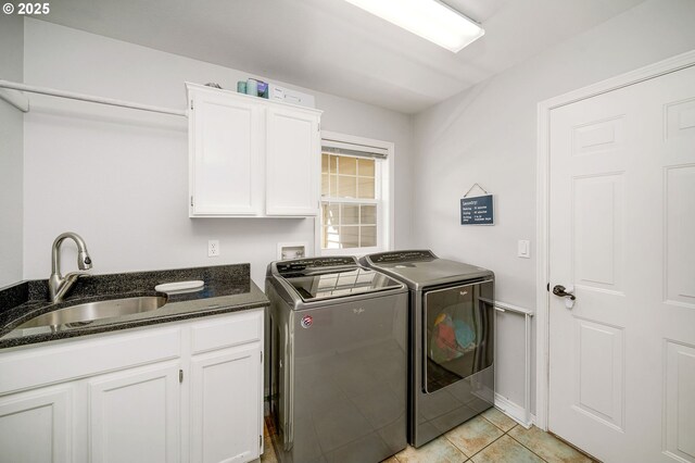17890 SW 109th Ave, Tualatin, OR 97062 - laundry area featuring washer and dryer, cabinet space, and light tile patterned floors