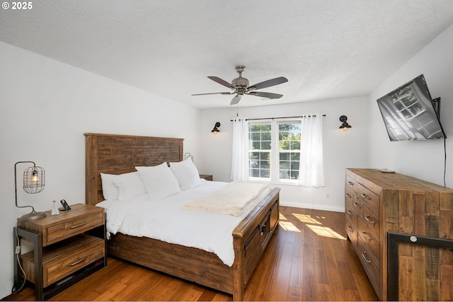 17890 SW 109th Ave, Tualatin, OR 97062 - bedroom featuring dark wood-style flooring, ceiling fan, and baseboards