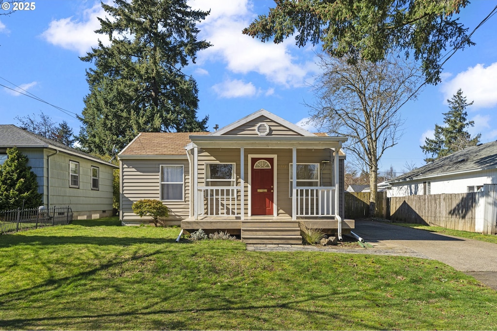 1157 SE 87th Ave, Portland, OR 97216 - view of front of property with covered porch, aphalt driveway, a front lawn, and fence