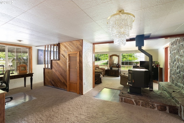 77690 Brock Rd, Oakridge, OR 97463 - carpeted office with a wood stove, a chandelier, and plenty of natural light
