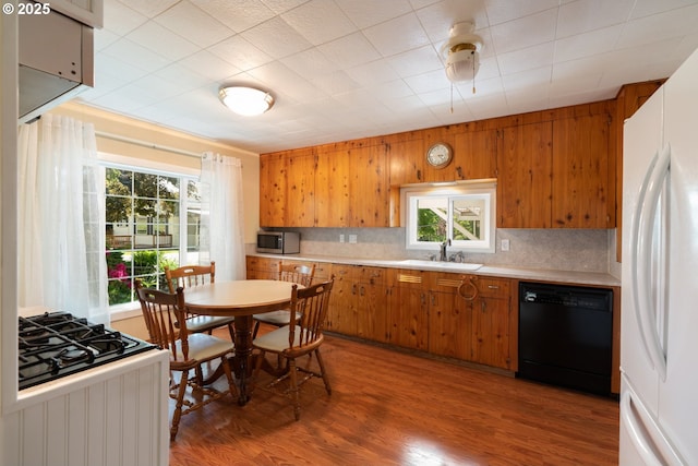 77690 Brock Rd, Oakridge, OR 97463 - kitchen featuring black dishwasher, freestanding refrigerator, stainless steel microwave, brown cabinetry, and light countertops