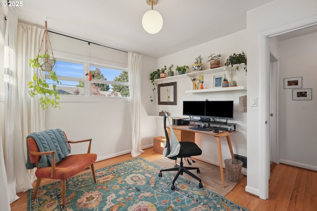 office with wood finished floors and baseboards