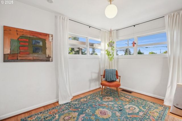 sitting room with wood finished floors and baseboards