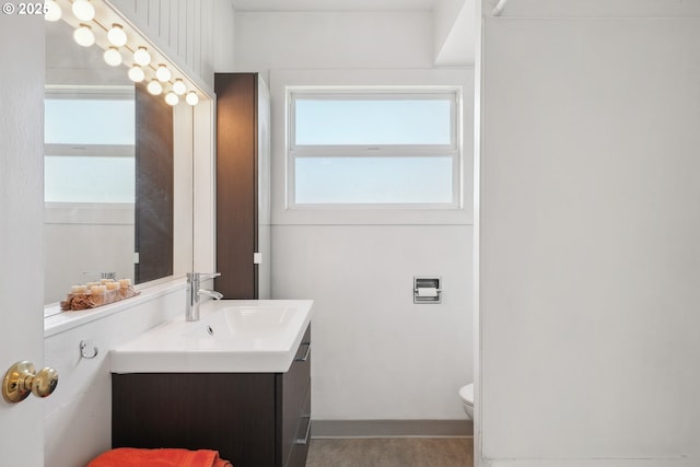 bathroom featuring toilet and vanity