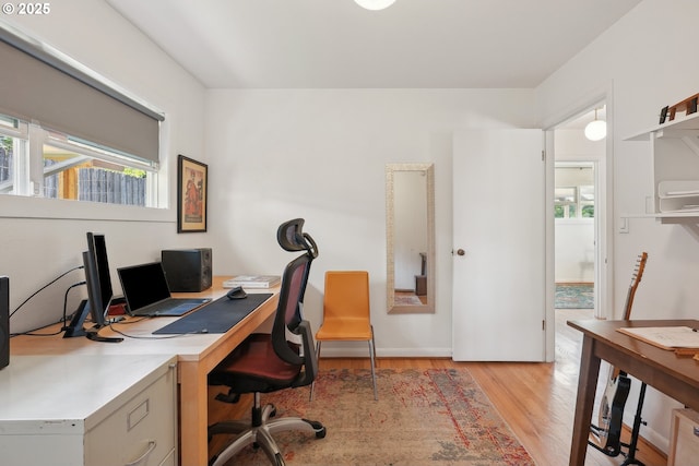 office area with light wood finished floors and baseboards