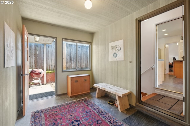 mudroom with concrete flooring and baseboards