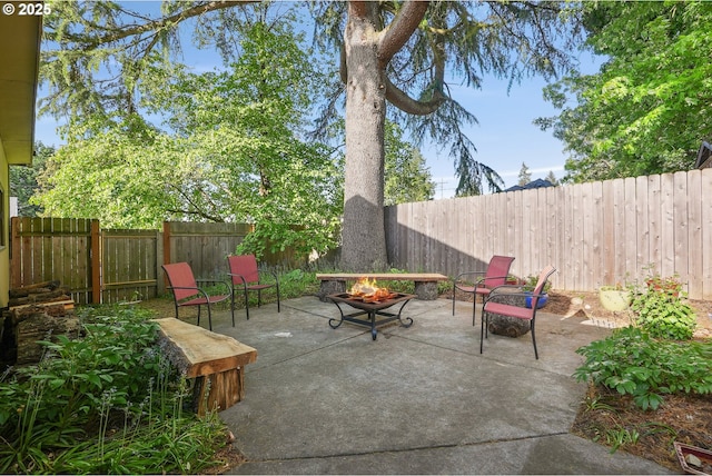 view of patio with a fire pit and a fenced backyard