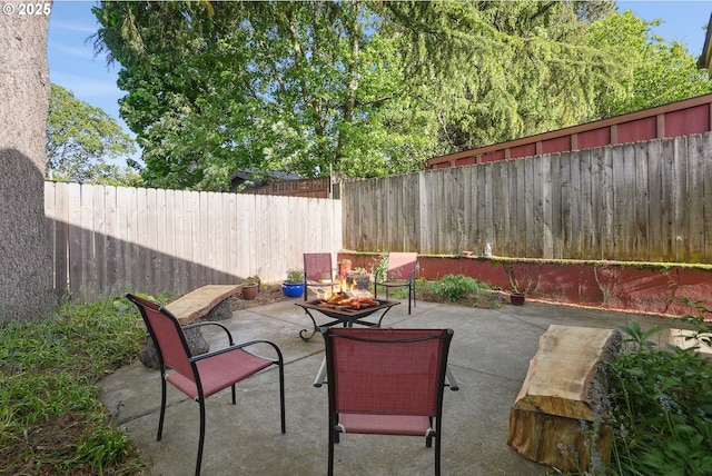 view of patio / terrace with an outdoor fire pit and a fenced backyard