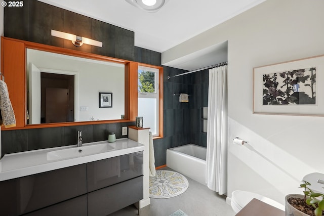 bathroom with shower / bathtub combination with curtain, vanity, and baseboards