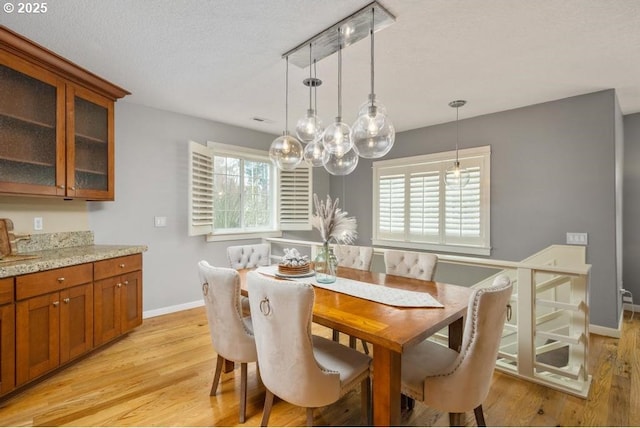 dining room with baseboards and light wood-style floors