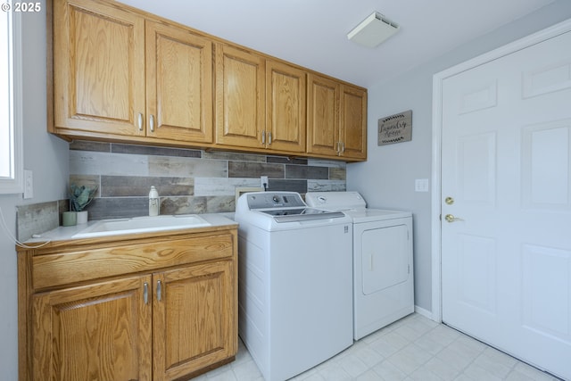 clothes washing area featuring cabinet space, separate washer and dryer, and light tile patterned floors