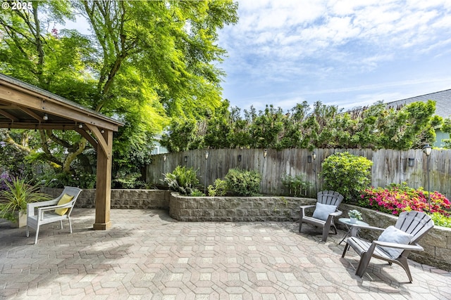 view of patio / terrace with a gazebo and a fenced backyard